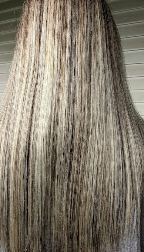 Dimensional blonde highlights styled straight, done at Sapphire Hair Studio